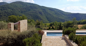 Stylish pool against backdrop of green hills in Umbria.
